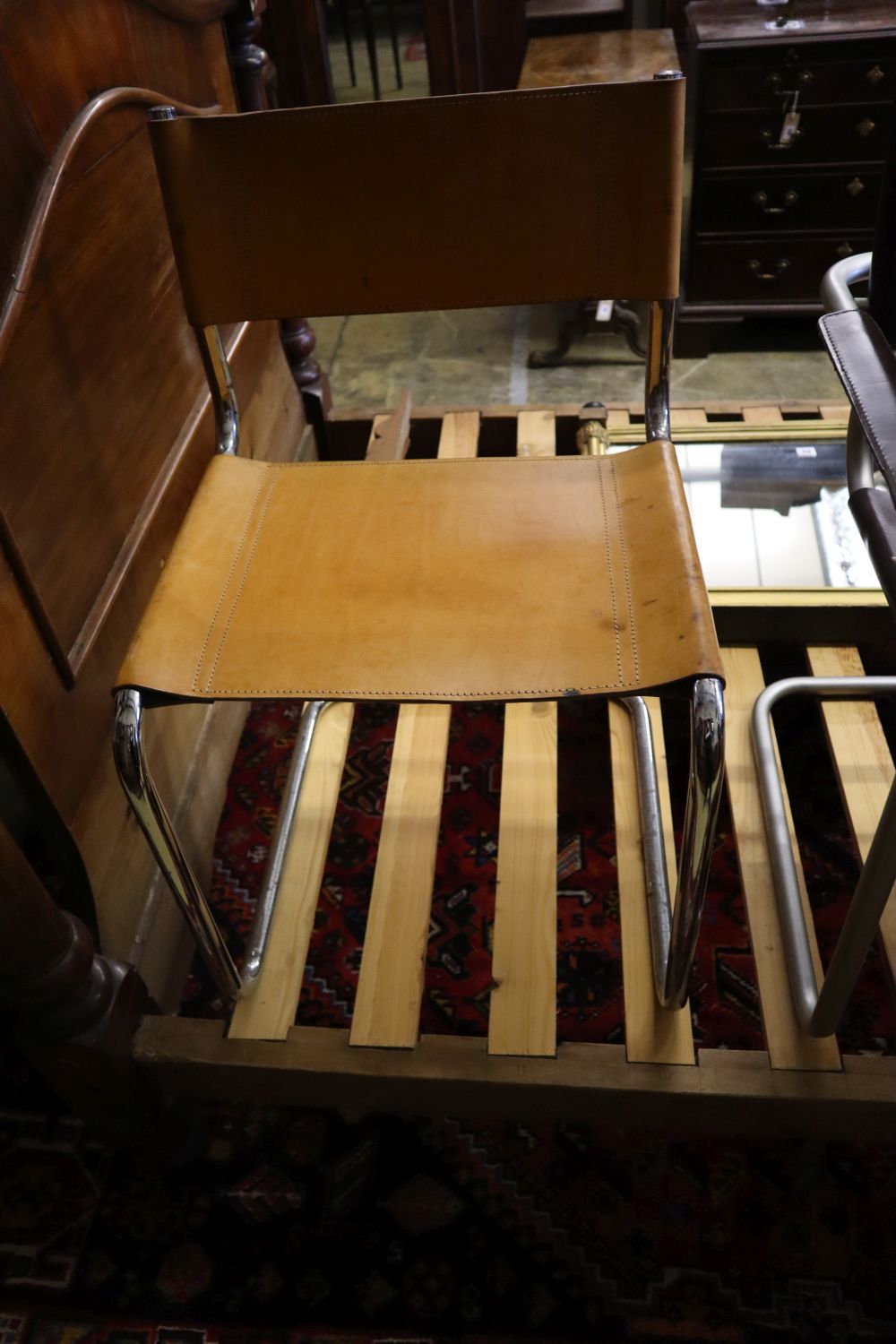 Three mid century design tubular metal and leather cantilever chairs